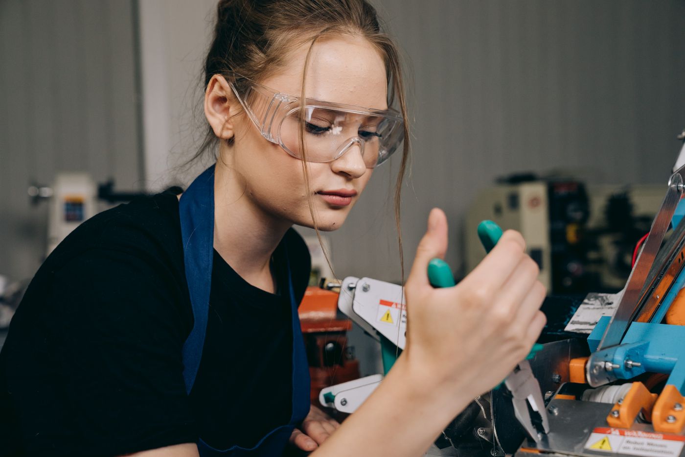 Young engineering apprentice working in a workshop